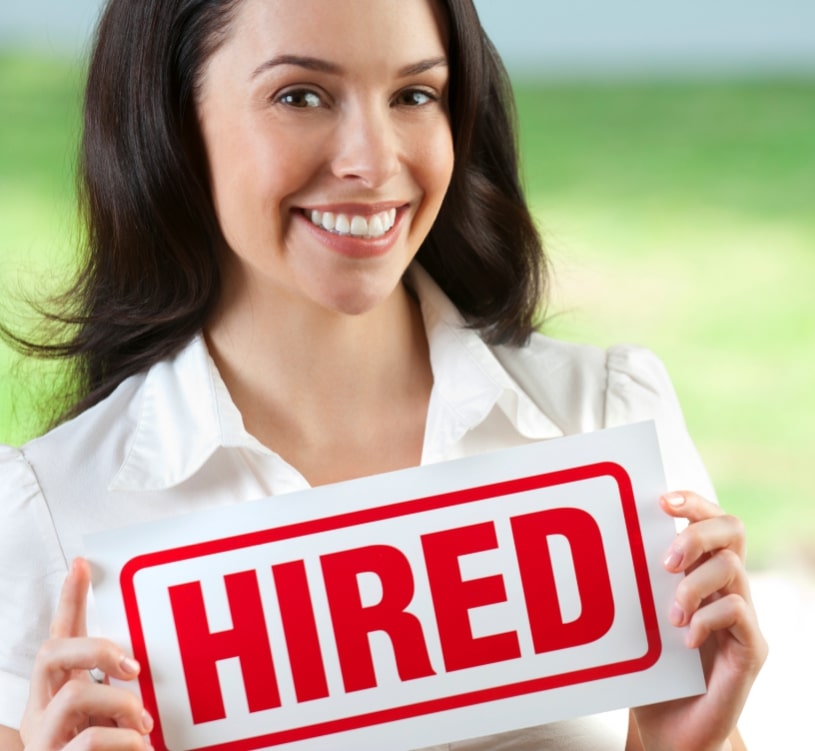 woman holding a hired sign